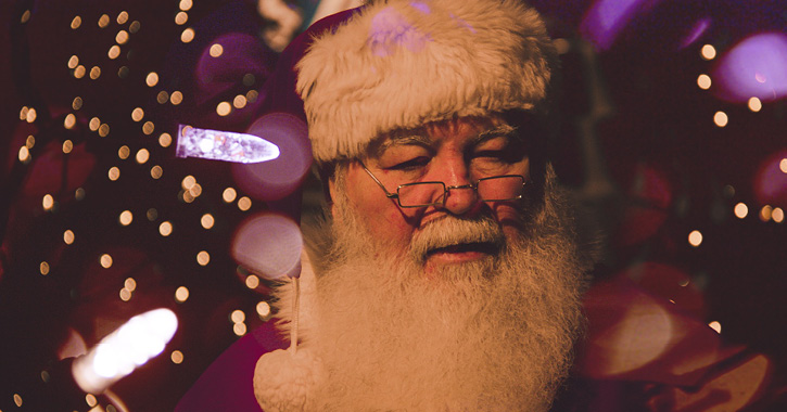 Father Christmas surrounded by fairy lights 